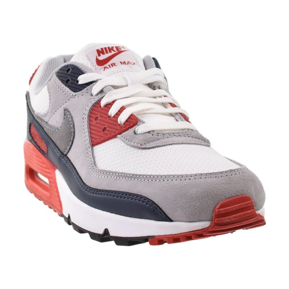 gray nike shoes with red swoosh